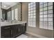 Bathroom vanity with modern vessel sink, decorative mirror, and glass block windows for privacy at 2885 Red Springs Dr, Las Vegas, NV 89135