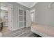 Bright bedroom featuring gray walls, modern fan, and white door leading to the bathroom at 2885 Red Springs Dr, Las Vegas, NV 89135