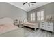 Charming bedroom with two beds, neutral walls, gray wood flooring, and modern ceiling fan at 2885 Red Springs Dr, Las Vegas, NV 89135
