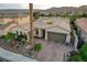 Beautiful single-story home showcasing desert landscaping, a tile roof, and a paved stone driveway at 2885 Red Springs Dr, Las Vegas, NV 89135
