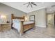 Comfortable main bedroom with a wooden bed frame, wood-look tile flooring, and soft, neutral tones at 2885 Red Springs Dr, Las Vegas, NV 89135