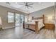 Cozy main bedroom with wood-look tile flooring, a ceiling fan, and sliding glass doors leading to the patio at 2885 Red Springs Dr, Las Vegas, NV 89135