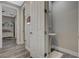 This powder room features a pedestal sink, white trim, and stylish gray wood flooring at 2885 Red Springs Dr, Las Vegas, NV 89135