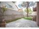 Wide angle shot of backyard features artificial grass, stone pavers, and block wall at 3025 Yankee Clipper Dr, Las Vegas, NV 89117
