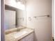 Powder room featuring granite countertop and faucet fixtures. Wall mounted towel racks and a mirror are also shown at 3025 Yankee Clipper Dr, Las Vegas, NV 89117