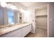 This bathroom features double sinks with a granite countertop and a walk-in closet at 3025 Yankee Clipper Dr, Las Vegas, NV 89117