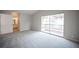 This bright bedroom has neutral carpet, light walls, and a sliding glass door leading to a balcony at 3025 Yankee Clipper Dr, Las Vegas, NV 89117