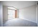 This bright bedroom has neutral carpet, light walls, and a sliding glass door leading to a balcony at 3025 Yankee Clipper Dr, Las Vegas, NV 89117