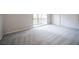 This bedroom has neutral walls, neutral carpet, a closet with sliding doors, and access to a balcony at 3025 Yankee Clipper Dr, Las Vegas, NV 89117
