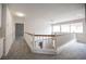 Upstairs hallway with wood railing and gray carpet; a hallway light fixture and access to several rooms are shown at 3025 Yankee Clipper Dr, Las Vegas, NV 89117