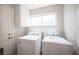 Laundry room features newer washer and dryer with a window for natural light at 3025 Yankee Clipper Dr, Las Vegas, NV 89117