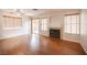 Spacious living room with a cozy fireplace, wood floors, and large windows that bring in natural light at 3025 Yankee Clipper Dr, Las Vegas, NV 89117
