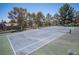 Full sized blue and green tennis court with net and trees at 3025 Yankee Clipper Dr, Las Vegas, NV 89117