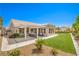 Serene backyard featuring a covered patio, manicured lawn, and tasteful landscaping at 3101 Hayden Ct, Las Vegas, NV 89134