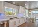 Bright kitchen with white cabinets, marble countertops, stainless appliances, and view of the backyard at 3101 Hayden Ct, Las Vegas, NV 89134