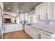 Kitchen featuring bright white cabinets and marble countertops that opens to a living space at 3101 Hayden Ct, Las Vegas, NV 89134
