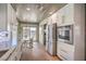 Well-lit kitchen featuring white cabinets, stainless steel appliances, and a breakfast nook with backyard view at 3101 Hayden Ct, Las Vegas, NV 89134