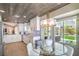 Modern kitchen with white cabinetry, stainless appliances, and a cozy breakfast nook overlooking the backyard at 3101 Hayden Ct, Las Vegas, NV 89134