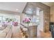 Open-concept living space with modern island seating, white kitchen, and stylishly coordinated living area at 3101 Hayden Ct, Las Vegas, NV 89134