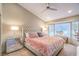 Bright main bedroom featuring a plush bed, mirrored nightstand, and large bay window with natural light at 3101 Hayden Ct, Las Vegas, NV 89134