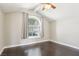 Bedroom featuring vaulted ceilings, ceiling fan, an arched window, and dark wood floors at 3249 Palmdesert Way, Las Vegas, NV 89120