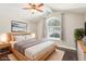 Bedroom features a bed, side tables, dark floors, and a large arched window at 3249 Palmdesert Way, Las Vegas, NV 89120