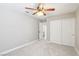 Neutrally painted bedroom features a ceiling fan and double-door closet for ample storage at 3249 Palmdesert Way, Las Vegas, NV 89120