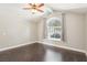 Bedroom featuring vaulted ceilings, ceiling fan, an arched window and dark wood floors at 3249 Palmdesert Way, Las Vegas, NV 89120