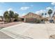 Inviting single-story home with large driveway and two car garage on a sunny day at 3249 Palmdesert Way, Las Vegas, NV 89120