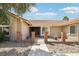 Close-up of home's entrance with gated front porch and beautiful desert landscaping at 3249 Palmdesert Way, Las Vegas, NV 89120