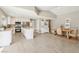 Bright kitchen and dining area features white cabinets, stainless appliances, and a large island at 3249 Palmdesert Way, Las Vegas, NV 89120