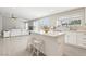 Bright kitchen and living area features white cabinets, an island with bar seating, and an open floor plan at 3249 Palmdesert Way, Las Vegas, NV 89120