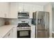 Modern kitchen features stainless steel appliances, white cabinets and gray subway tile at 3249 Palmdesert Way, Las Vegas, NV 89120