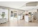 Modern kitchen and dining area with white cabinetry, stainless appliances, and sliding glass door to backyard at 3249 Palmdesert Way, Las Vegas, NV 89120
