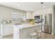 Modern kitchen with stainless steel appliances, white cabinetry, stylish backsplash, and breakfast bar island at 3249 Palmdesert Way, Las Vegas, NV 89120