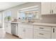 Kitchen featuring stainless steel dishwasher, double basin sink, and bright white cabinets at 3249 Palmdesert Way, Las Vegas, NV 89120