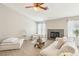 Comfortable living space with a cozy fireplace, wood look tile floors, and natural light at 3249 Palmdesert Way, Las Vegas, NV 89120