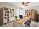 Inviting home office with built-in bookshelves, a spacious desk, and a comfortable chair at 3249 Palmdesert Way, Las Vegas, NV 89120