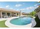 Sparkling pool and spa in a private backyard with lush landscaping and a covered patio at 3249 Palmdesert Way, Las Vegas, NV 89120