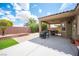 Covered patio with furniture and a grill in the backyard at 3696 Waynesvill St, Las Vegas, NV 89122