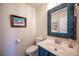 Charming bathroom with a decorative mirror, painted vanity, and modern fixtures at 3696 Waynesvill St, Las Vegas, NV 89122