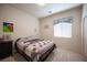 Cozy bedroom with plush carpet, natural light, and a relaxing atmosphere at 3696 Waynesvill St, Las Vegas, NV 89122