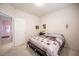 Relaxing bedroom with a comfortable bed, soft carpet, and an open doorway at 3696 Waynesvill St, Las Vegas, NV 89122