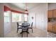 Bright dining area featuring a round table, four chairs, and a window with decorative valance at 3696 Waynesvill St, Las Vegas, NV 89122
