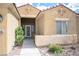 Inviting front entrance featuring decorative door, desert landscaping, and a covered walkway at 3696 Waynesvill St, Las Vegas, NV 89122