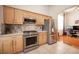 Modern kitchen featuring stainless steel appliances and granite countertops, with views to the living area at 3696 Waynesvill St, Las Vegas, NV 89122