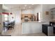 Open kitchen with stainless steel appliances, granite countertops, and a breakfast bar at 3696 Waynesvill St, Las Vegas, NV 89122