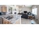 Open-concept kitchen leading into a cozy living room with fireplace and entertainment center at 3696 Waynesvill St, Las Vegas, NV 89122