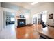 Spacious living room with hardwood floors, a fireplace, and ample natural light at 3696 Waynesvill St, Las Vegas, NV 89122