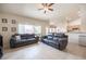 Bright living room with neutral colors, tile floors, and comfortable seating at 3696 Waynesvill St, Las Vegas, NV 89122
